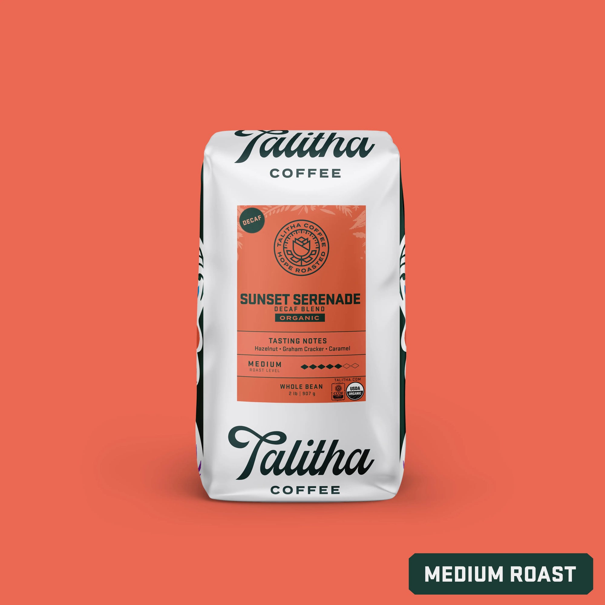 Packaging for Talitha Coffee's Sunset Serenade decaf blend. The bag is white with a floral pattern and a label that includes the product name, tasting notes, and 'medium roast' designation.