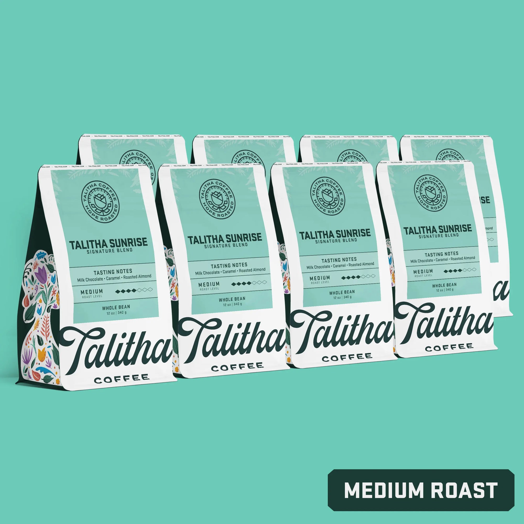 Multiple bags of 12oz Talitha Sunrise blend medium roast on teal background