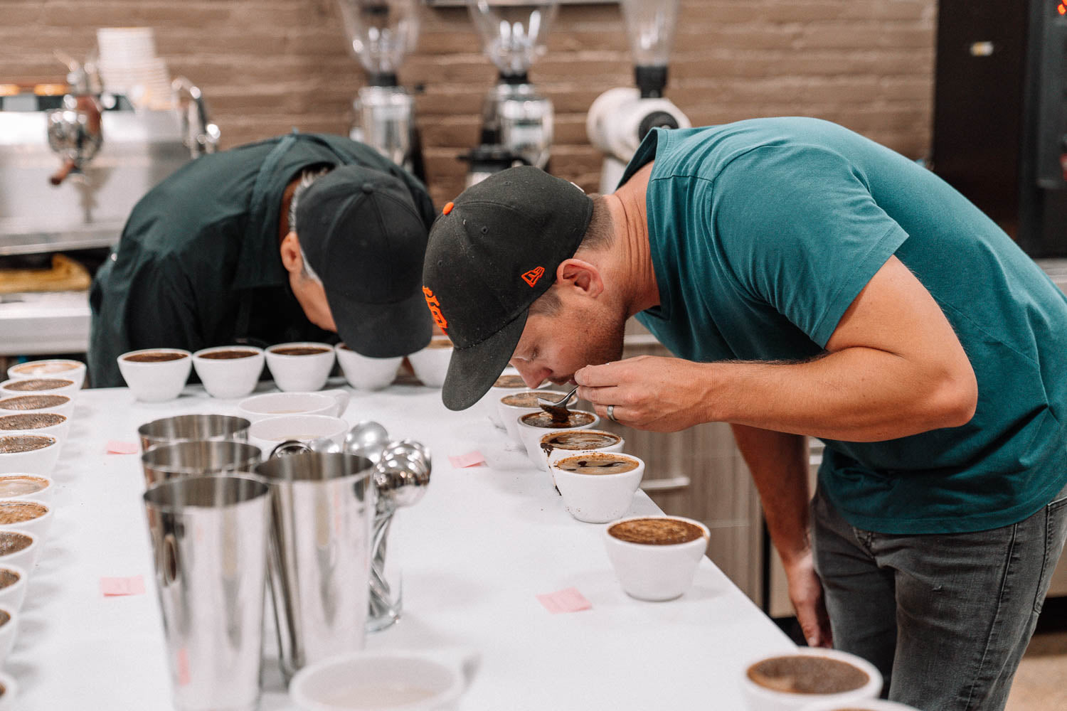 Two Talitha staff members doing a coffee cupping 
