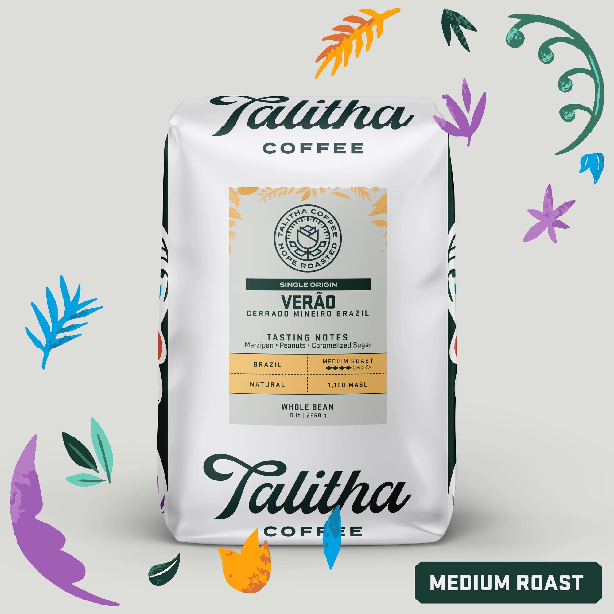 A package of Talitha Coffee, featuring a single origin Brazil coffee named 'Verão'. The packaging is white with a colorful floral pattern and text detailing the coffee's tasting notes and roast level, which is medium roast.